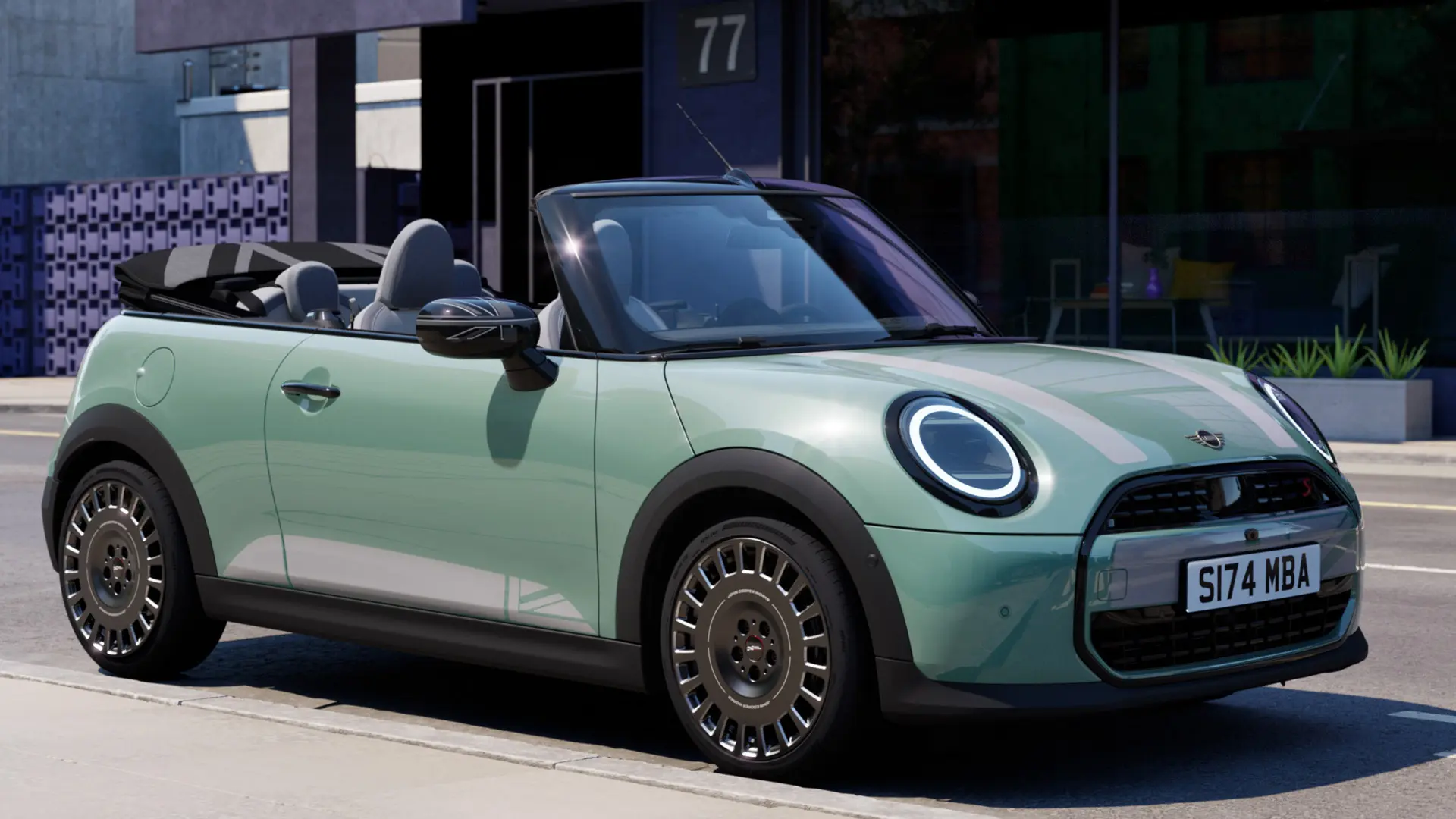 Front side view of MINI Convertible in Ocean Wave Green with MINI Heritage bonnet decals in white. 