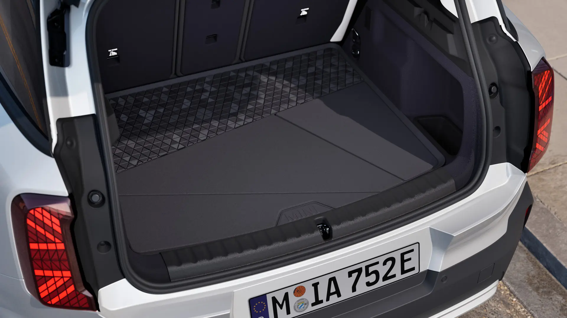 Black, custom-fit MINI boot compartment mat with high all-round edge to protect against dirt and moisture.