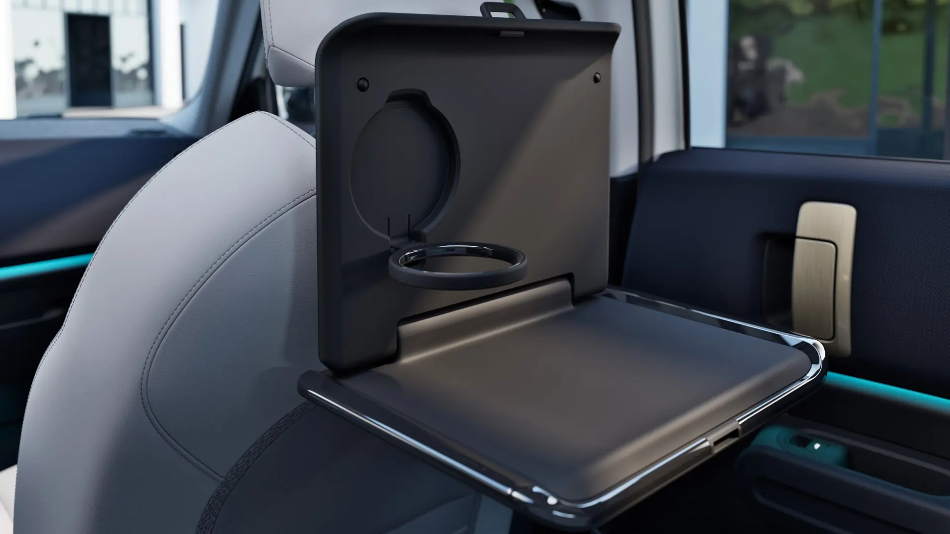 Close up of practical MINI folding table for the back seat attached to the basic carrier, features integrated cup holder. 