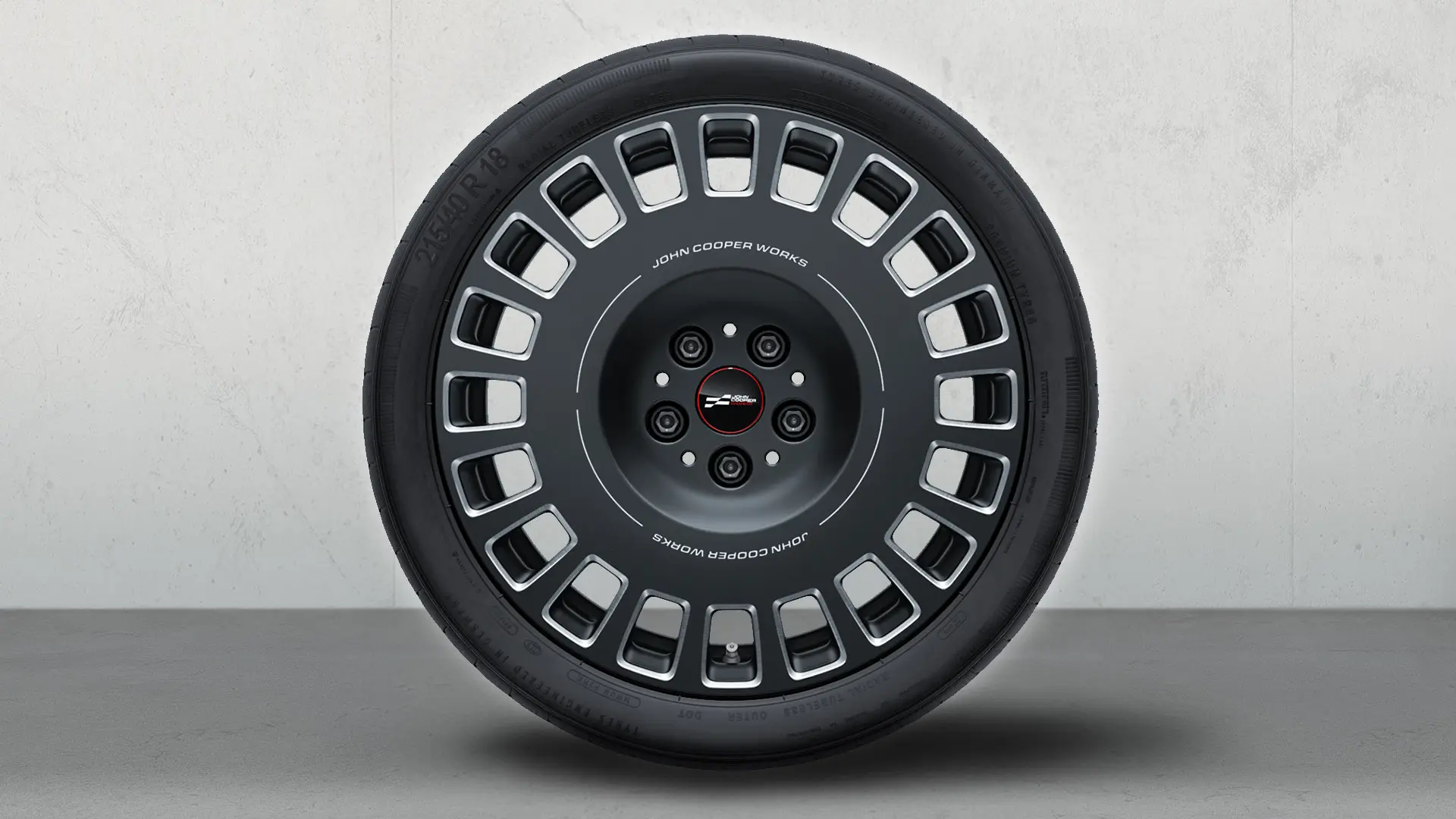 MINI JCW 18" Rallye Spoke 964 wheel in Frozen Midnight Grey and diamond-milled finish.