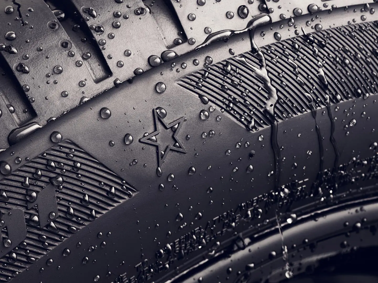 Close-up of a tyre sidewall showing the star symbol, which indicates it is approved for optimal performance on MINI vehicles. 