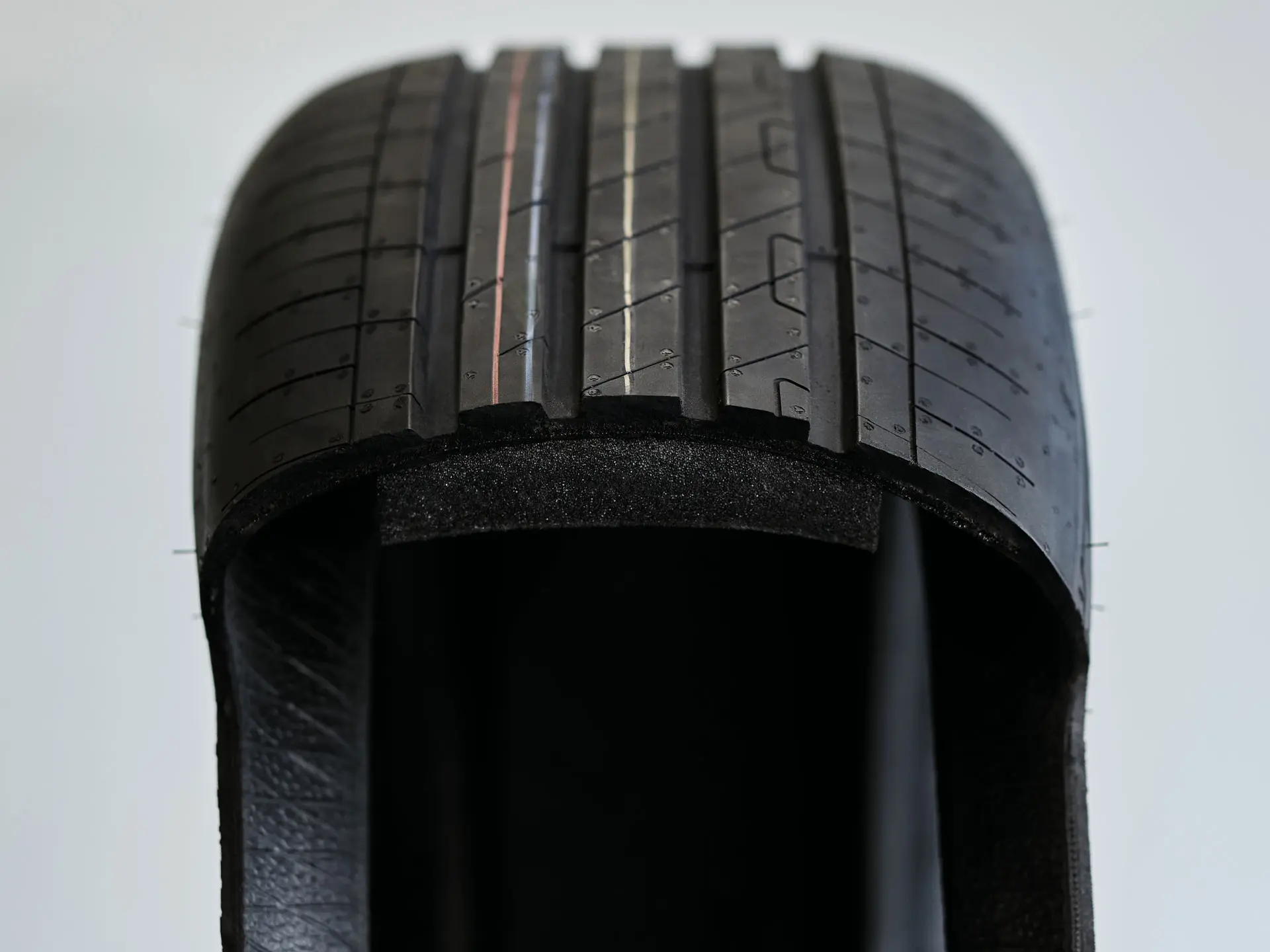 Cutaway view of a run-flat tyre showing the thickened, sturdy sidewall that supports the vehicle weight after a puncture.