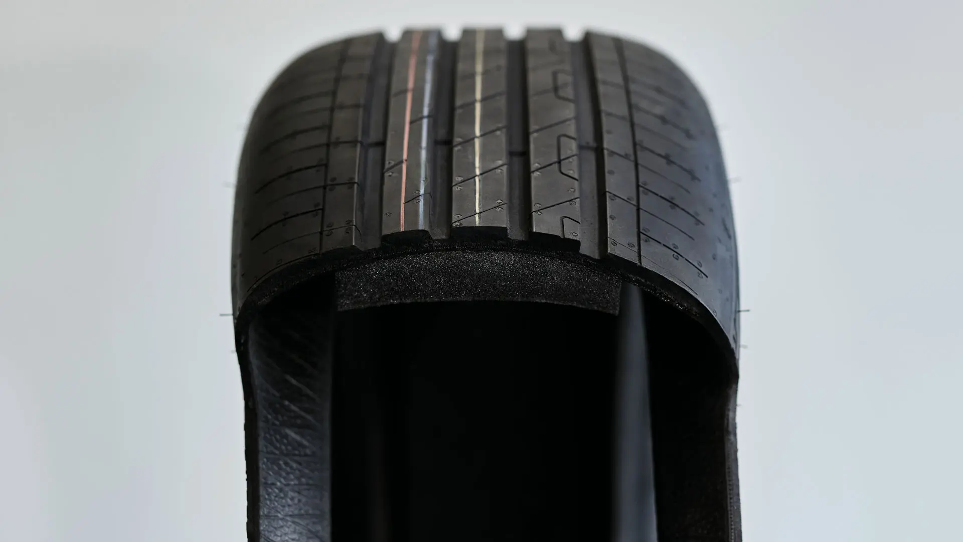 Cutaway view of a run-flat tyre showing the thickened, sturdy sidewall that supports the vehicle weight after a puncture.