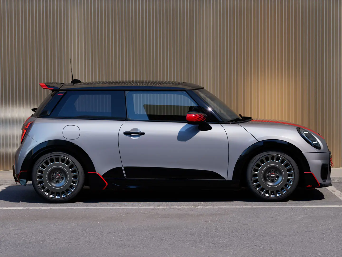 MINI Cooper 3-door in Melting Silver with John Cooper Works roof spoiler for enhanced aerodynamic properties – side view.