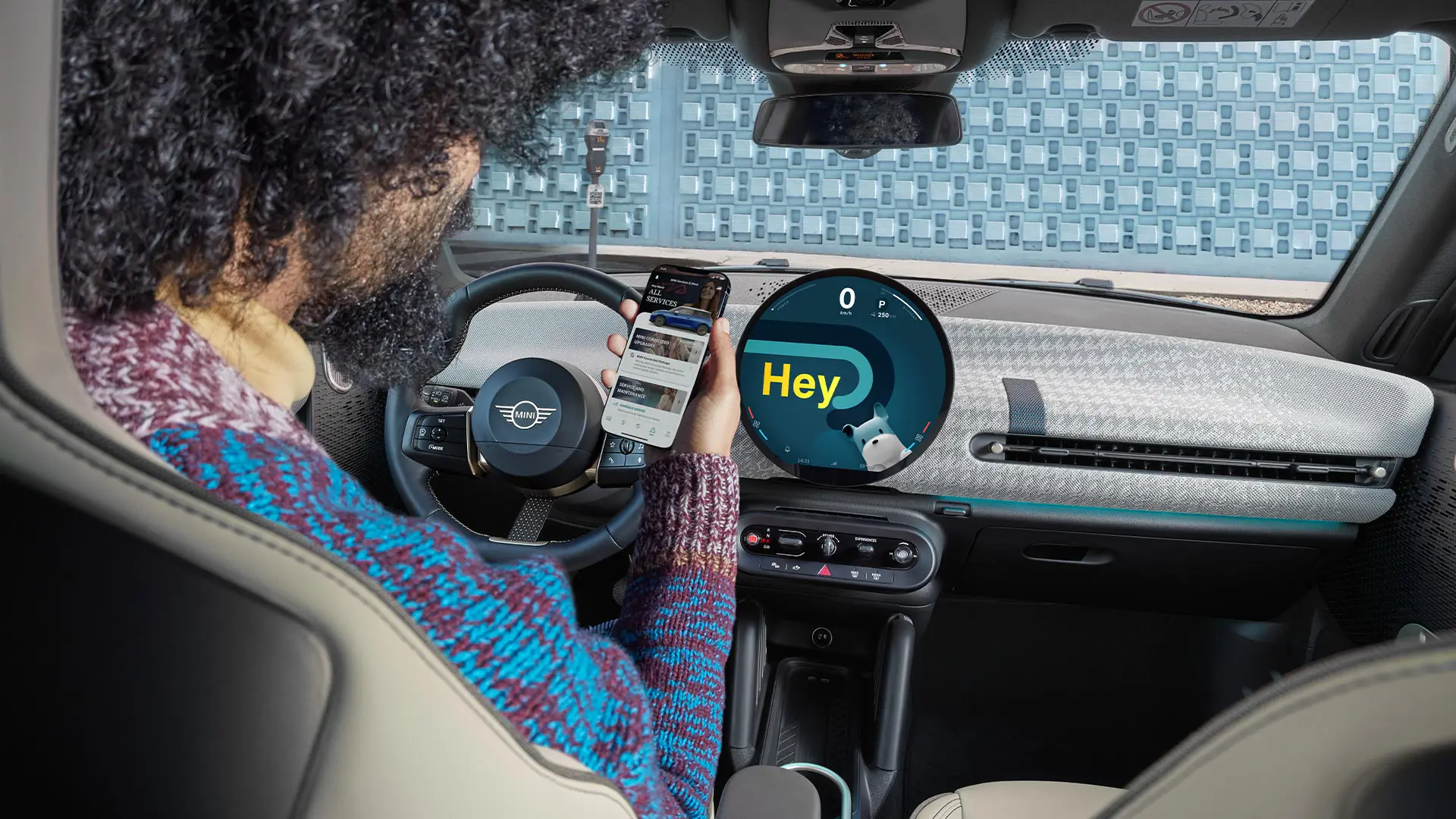 A man sitting in a MINI looking at his phone