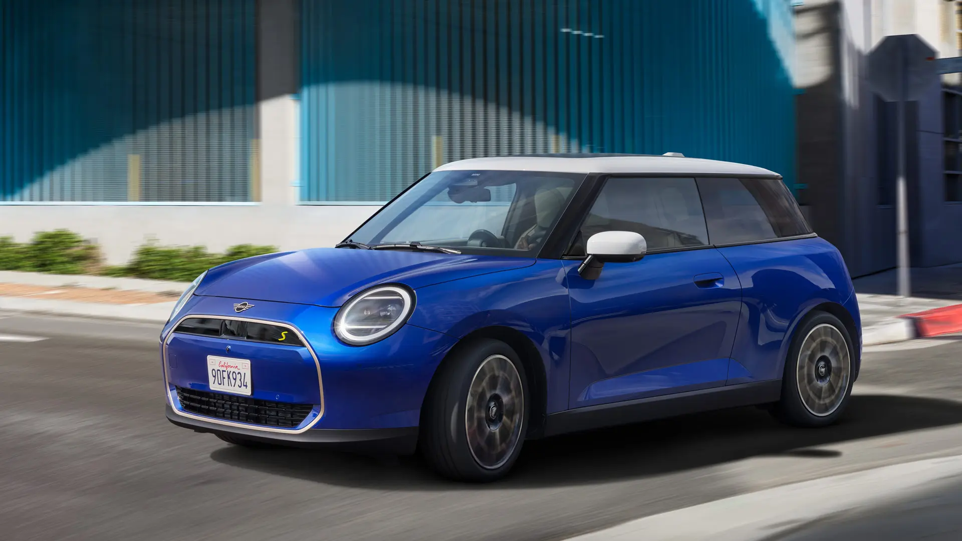 A MINI Cooper drives dynamically