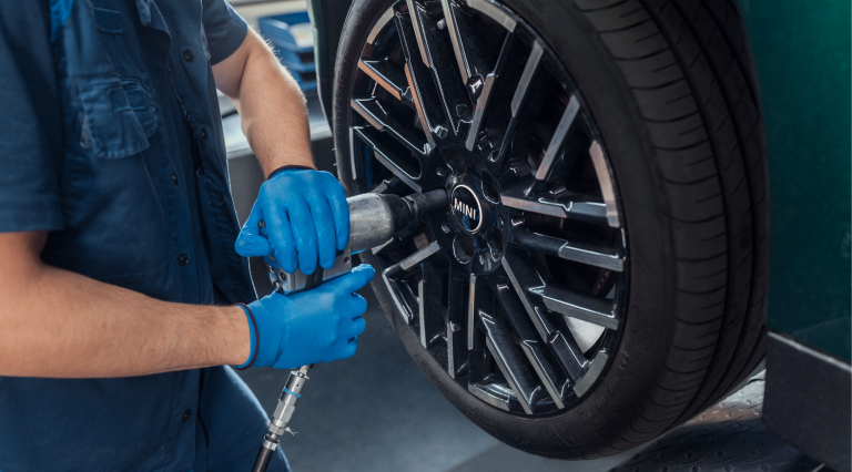 A man sitting in a MINI looking at his phone