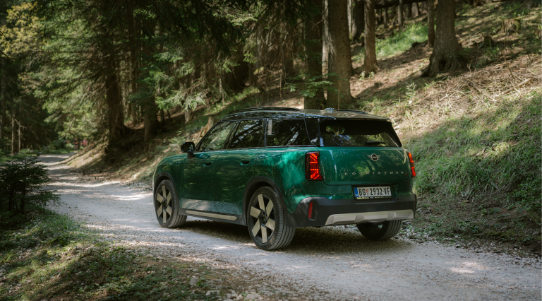 A man sitting in a MINI looking at his phone