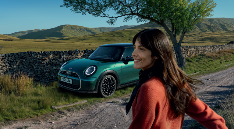 A man sitting in a MINI looking at his phone