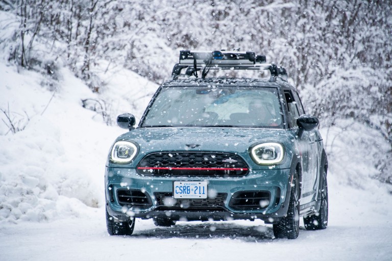 Picture of a MINI Countryman driving through the snowy landscape of British Columbia, Canada. 